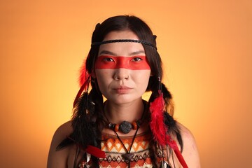 Shaman woman with face painting on orange gradient background