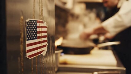 Gritty Close-up of Worn American Flag Sticker in Industrial Kitchen with Chef Working Hard in Slow Motion