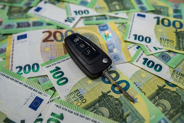 Car key on euro bills, auto finance and purchase concept for vehicle ownership