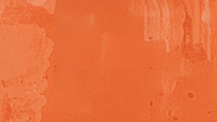 Fototapeta premium Venetian plaster, a decorative wall covering, red warm color, primer, plaster texture, painted with bright orange paint, with streaks and scuffs