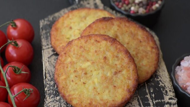 Hash browns, fried potato and onion pancakes with spices for breakfast. Fried hash browns