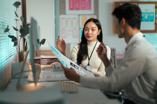 Product designers collaborating on user interface application blueprint