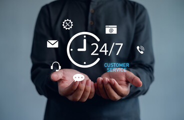 24-7 customer service concept with business person holding digital communication icons. Representing online support, helpdesk, call center, and technology assistance for clients anytime.