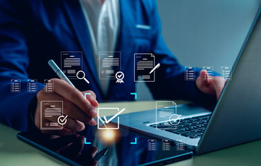business professional using a laptop and tablet for digital document approval and e-signature. Concept of online verification, paperless workflow, business automation, and data compliance.