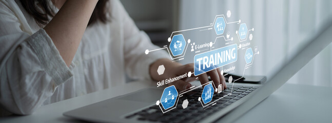 A focused young professional uses a laptop for an online training session, enhancing skills through...