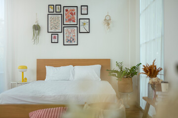 Cozy Bedroom With Wooden Bed, Colorful Decor, and Natural Light in a Bright Living Space