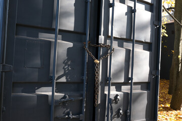 Chain-secured doors standing in autumn's golden light