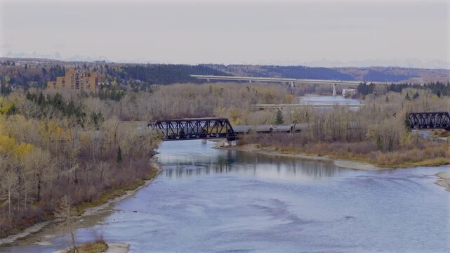 Freight train running along a bridge over the Bow River at Bowmont Park in Calgary, Alberta, HDR