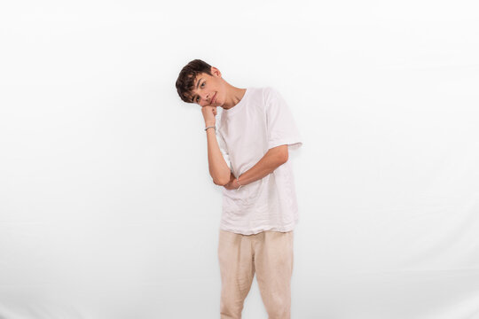 chill aloof laidback young casual dressed white male model teenage boy is ambivalent too cool for school. unbothered relaxed Gen Z plain background studio setting	