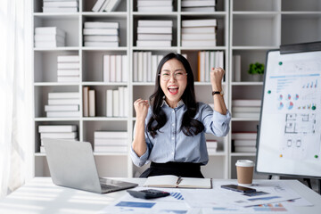 Accounting business concept, Accountant woman reading good news on laptop with excited face and raising