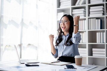 Accounting business concept, Accountant woman reading good news on laptop with excited face and raising