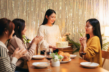 Group of Young Adult Asian Women Celebrating Birthday Party with Cake and Candles at Home Friendship Happiness Event Gathering Concept
