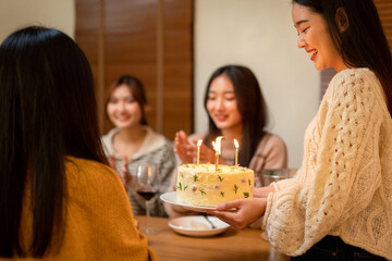 Young Asian Woman Holding Birthday Cake with Friends Celebration Happy Birthday Party Event Gathering Dinner with Friends Cake and Candles