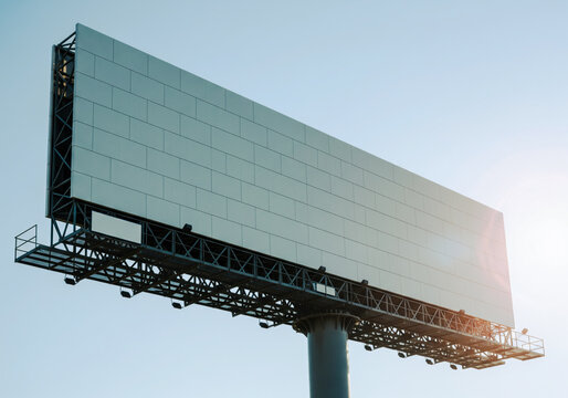 Mockup outdoor megaboard billboard against blue sky close up steel truss structure sun edge light realistic panel texture with spacious copy space for brand message