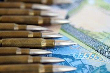 Bahraini dinar currency money bills and rifle bullets close up. The concept of warfare and gun selling