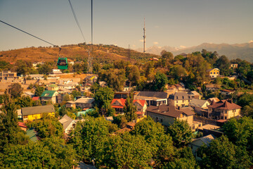 Scenic view of the Kok-Tobe cable car traveling high above the residential districts of Almaty, Kazakhstan, as it climbs Kok Tobe Hill