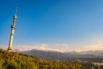 Obraz premium Scenic view of the Almaty Television Tower, the world's tallest free-standing tubular steel structure, on the slopes of Kok-Tobe in Almaty, Kazakhstan, with Altai Mountains in the background