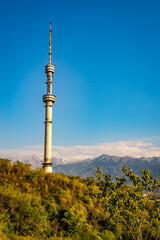 Scenic view of the Almaty Television Tower, the world's tallest free-standing tubular steel structure, on the slopes of Kok-Tobe in Almaty, Kazakhstan, with Altai Mountains in the background