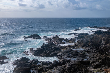 Dramatic volcanic cliffs rise above Atlantic ocean on Madeira island, natural landmark, geological beauty, seascape view, lava rocks and deep blue ocean
