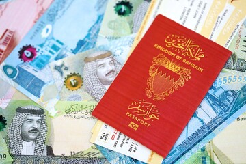 Bahraini dinar currency money bills with tickets and passport close up. The concept of travel and vacation
