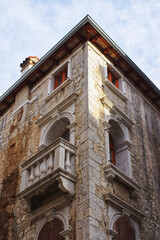 Old stone building facade with balcony detail