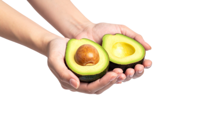 A pair of hands delicately holding halves of a fresh avocado