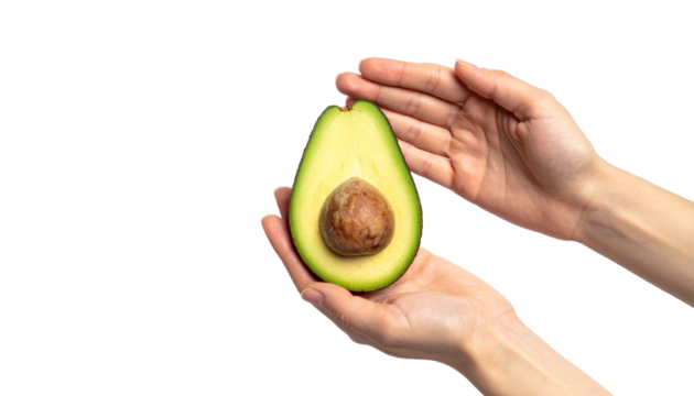A pair of hands delicately holding a cut avocado, showcasing its creamy green flesh and a single seed