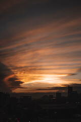 Sunset in the city with beautiful warm tones over the clouds