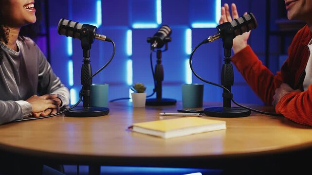 Podcast maker shaking hands and bumping fists with guest after studio interview