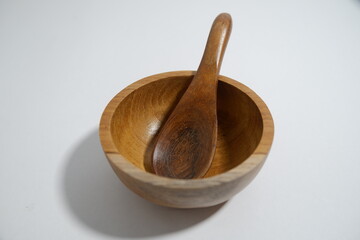 wooden bowl with spoon placed isolated on white background