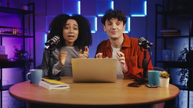 Two podcasters waiting for goal while commenting sports match during live stream