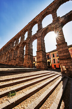 sunlight shinning through the ancient Roman aqueduct in Segovia, Spain, Europe