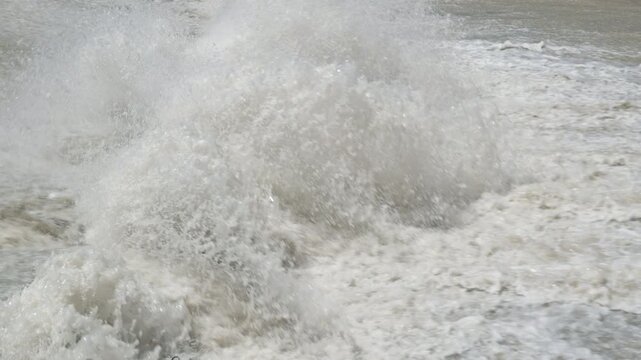 row of chute dentate blocks in concrete water spillway channel slope slowing down splashing flow of water running down.