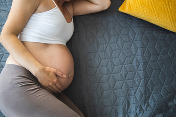 pregnant young woman sleeps in the bed