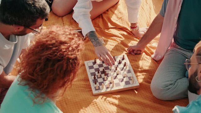 Friends Playing Chess at a Picnic