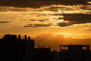 Sunset in the city with beautiful warm tones over the clouds