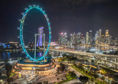 Aerial view of the radiant Singapore Flyer and the Esplanade bridge illuminating the skyline against the night, Singapore, Central Singapore Community Deve, Singapore.