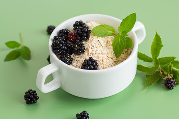 Breakfast oatmeal with blackberries and mint