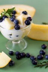 Nutritious protein snack yogurt with blueberries and melon cubes