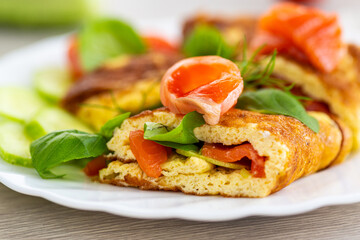 Classic omelet with red fish and fresh vegetables