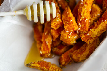 Healthy grilled pumpkin pieces drizzled with natural honey