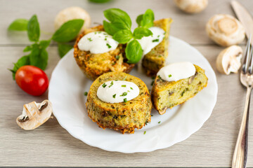 Homemade potato muffins with mushrooms and sour cream topping