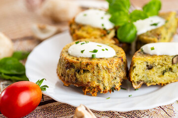 Rustic homemade potato and mushroom muffins with green garnish