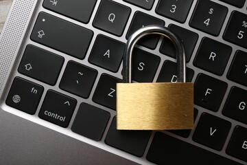 Password concept. Closed padlock on laptop, top view