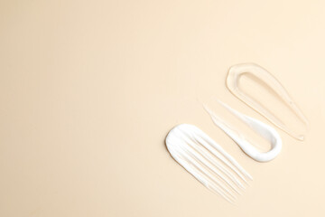 Samples of different cosmetic products on beige background, flat lay. Space for text