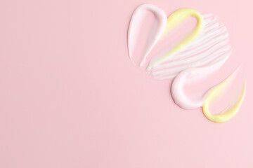 Samples of different cosmetic products on pink background, flat lay. Space for text