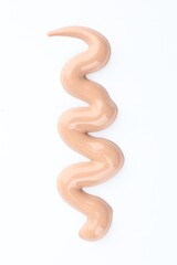 Sample of foundation on white background, top view