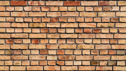 Old textured brick wall in shades of orange and beige with rough surface. Concept of construction background, industrial texture, architectural vintage detail