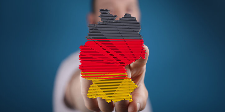 Close-up of a hand presenting a 3D model of Germany, showcasing its flag colors.