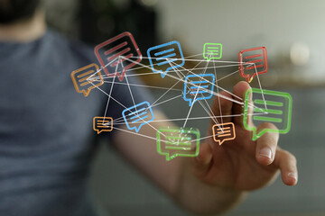 Concept of communication through technology and networking illustrated with hand touching digital chat bubbles, connection and social media.